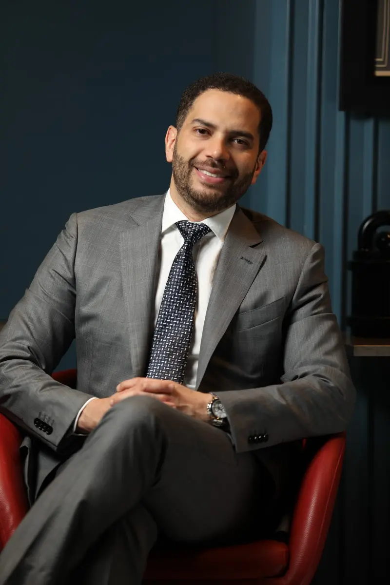 Dr. Gustavo Almanzar sitting in his office